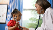 Doctor checking childs heartbeat